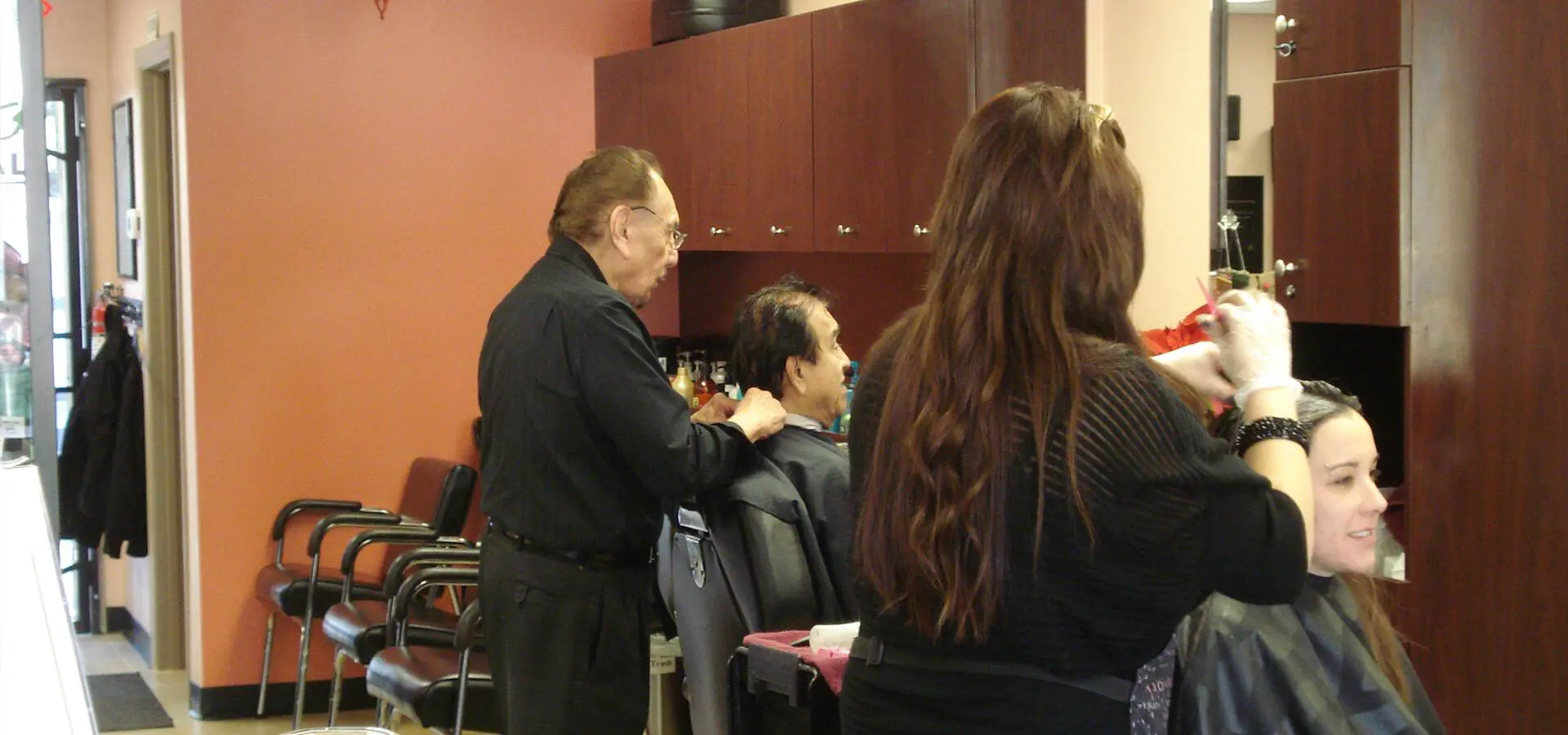 The real Shearology team working with clients inside the Mission Valley salon