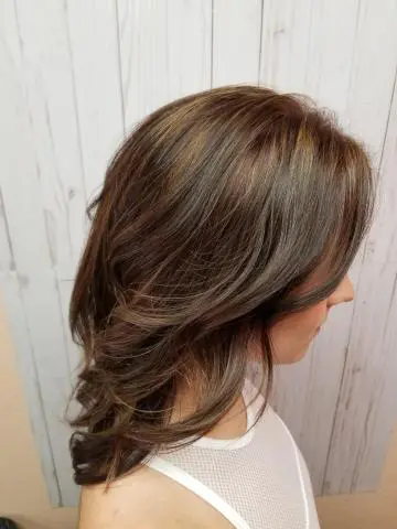 A real Shearology client with a soft, layered chestnut cut